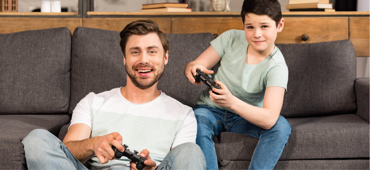 Father and son playing videos games together